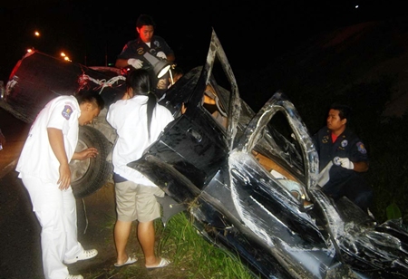 Rescue workers wait for the arrival of the Jaws of Life, and were eventually able to free Bunyiem Phookhaengmok from his crumpled pickup.